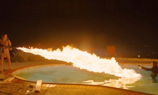 A man fires a flamethrower at a girl in a pool in Once Upon a Time in Hollywood.